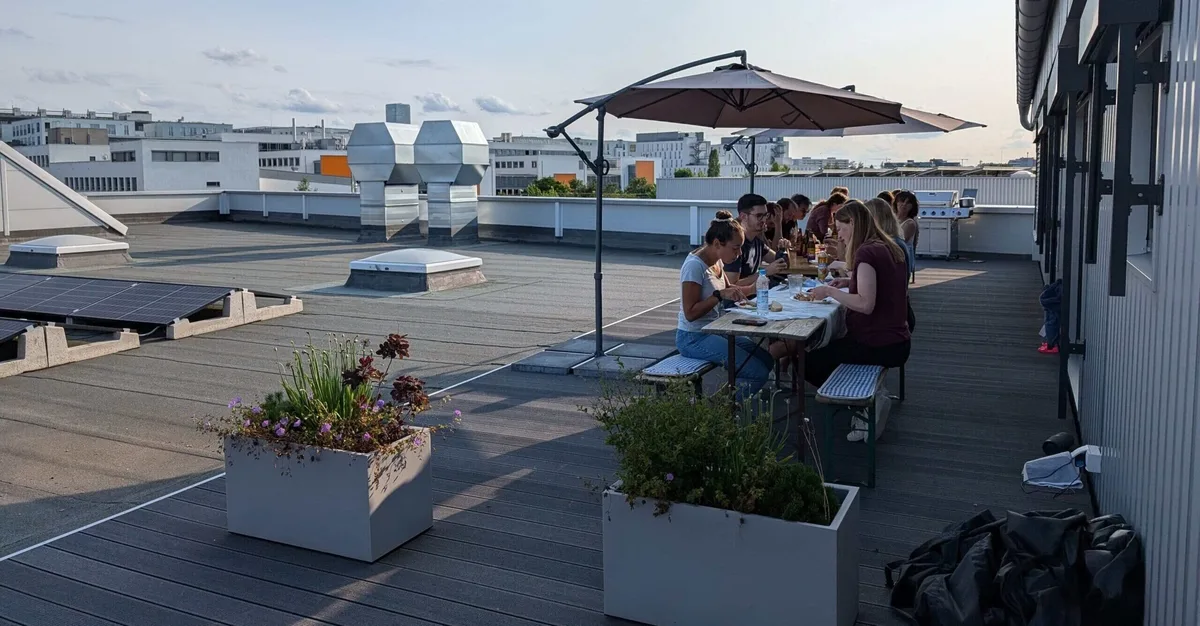 The team having dinner together on the office roof terrace in Munich